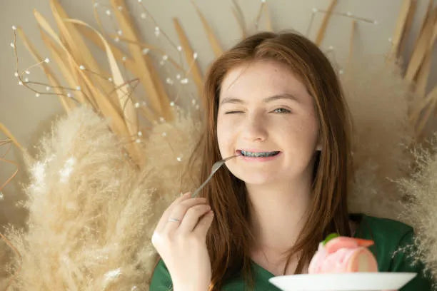 Person with braces enjoying cake safely