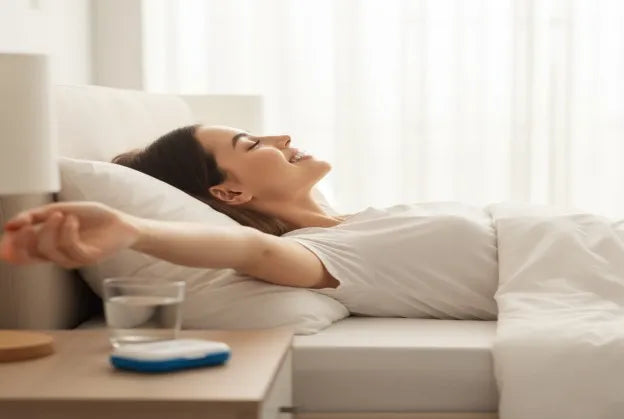 Woman waking up headache-free after using a night guard